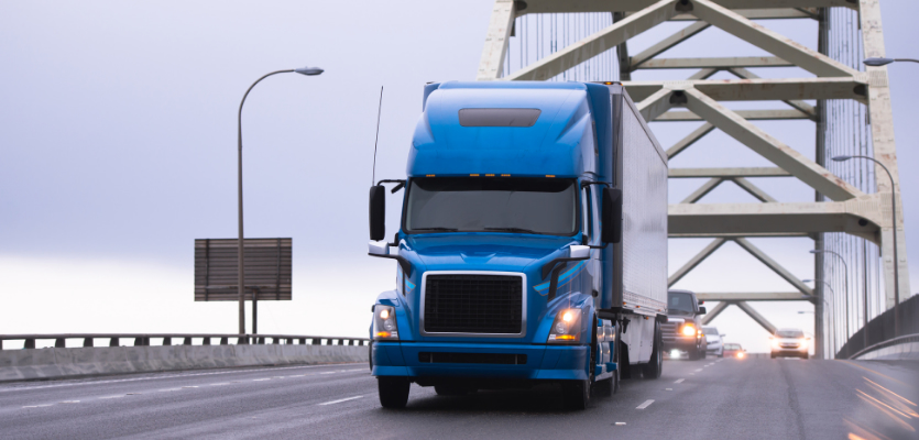 semi truck driving on a bridge