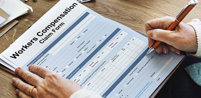 omeone filling out workers compensation claim form