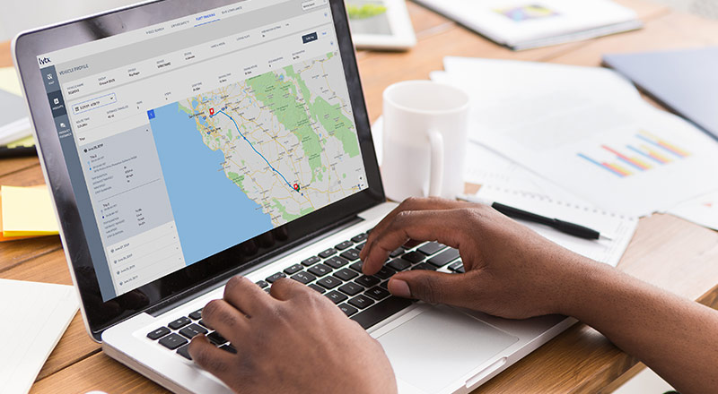 Open laptop with fleet tracking map on the screen