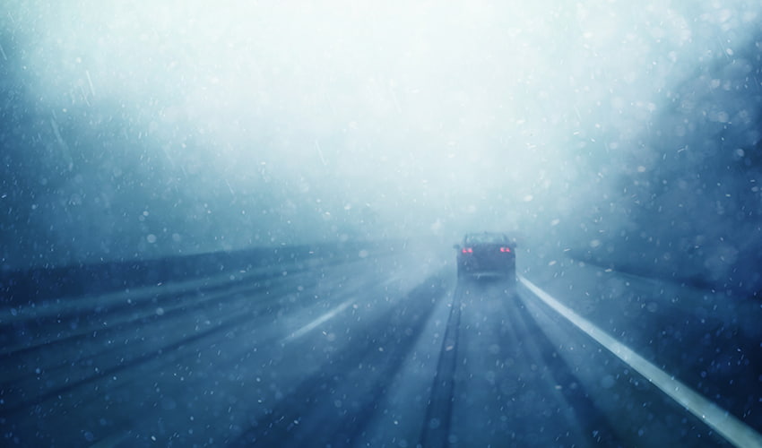 car driving on rainy road