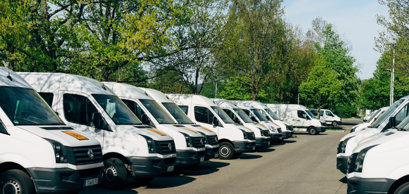 a line of up identical vans in a parking lot