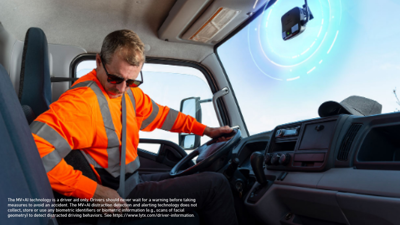 truck driver with in-cab fleet safety technology