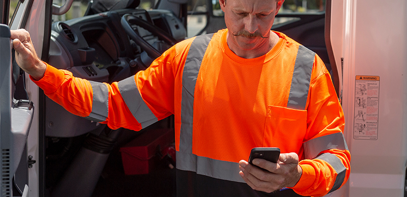 Drive standing outside of vehicle on their phone