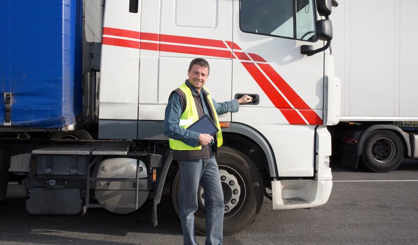 truck driver in front of a semi truck