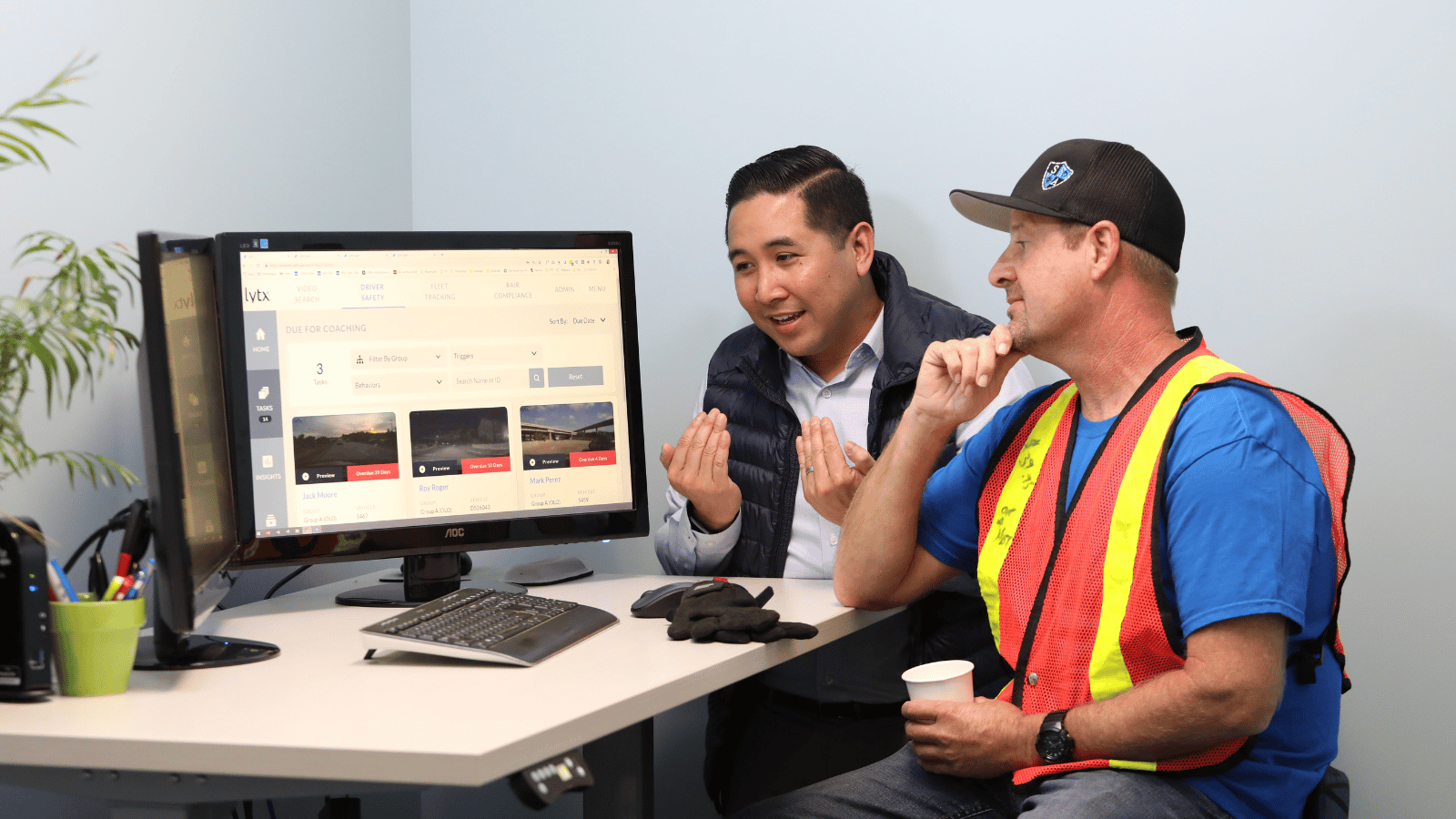 driver and coach looking at computer