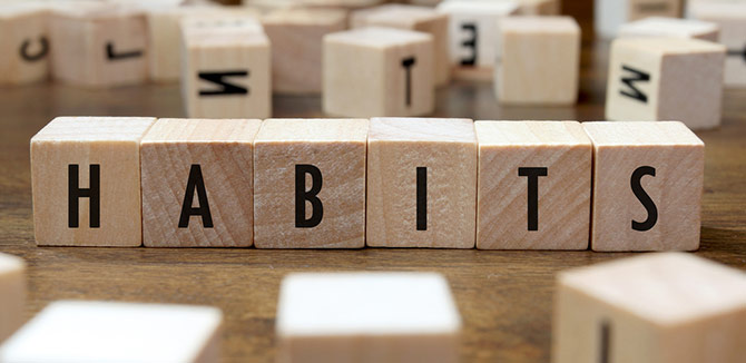 The word :Habits" spelt out with wood playing blocks