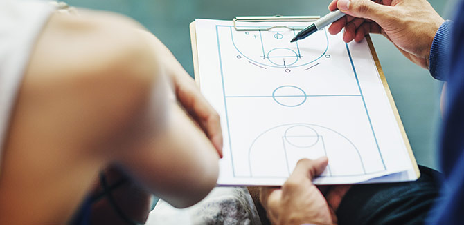 Clip board with an outline of a basketball court on it