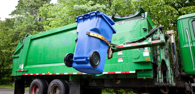 waste vehicle picking up trash can