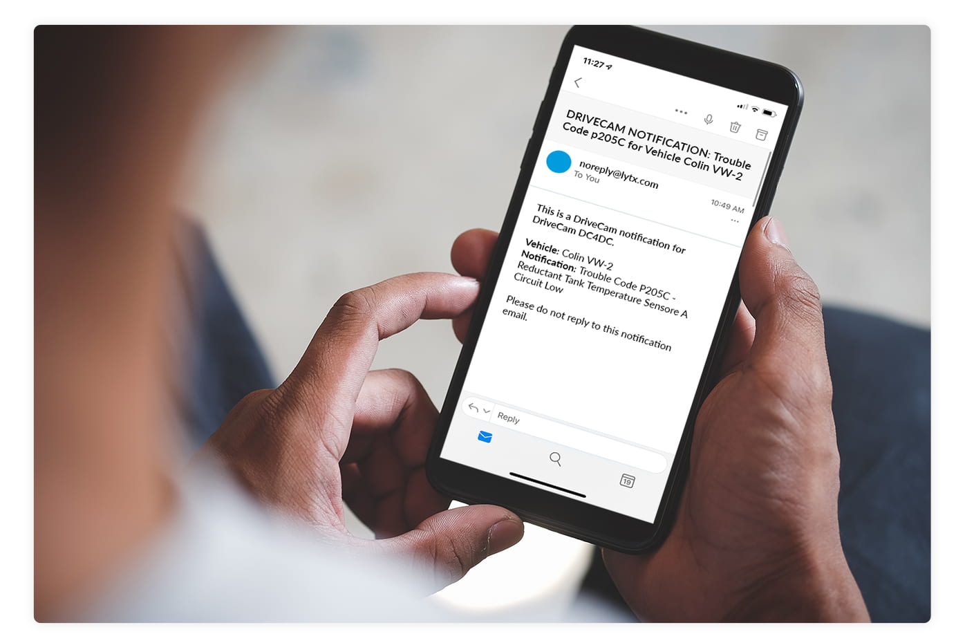person holding a smartphone with an email notification from Lytx