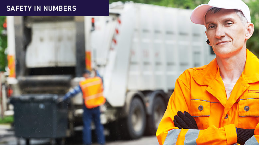 drivers standing in front of a waste vehicle