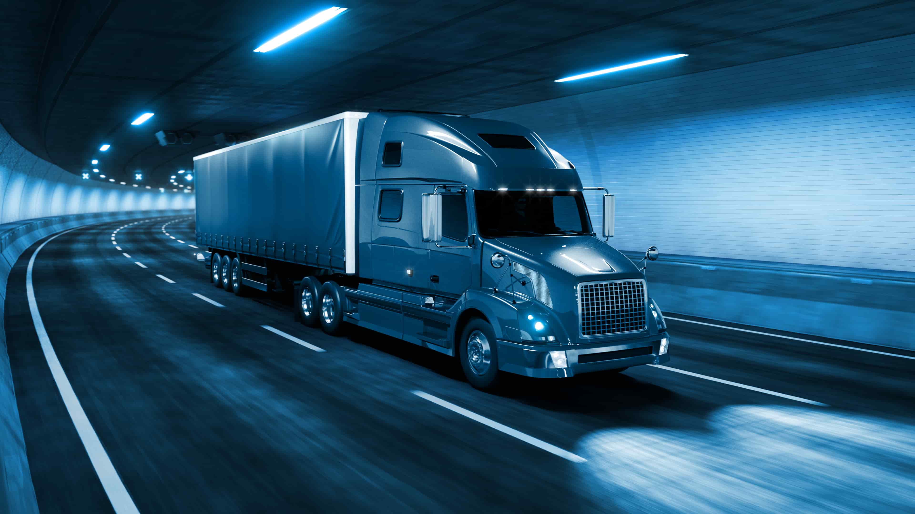 semi truck driving through a tunnel