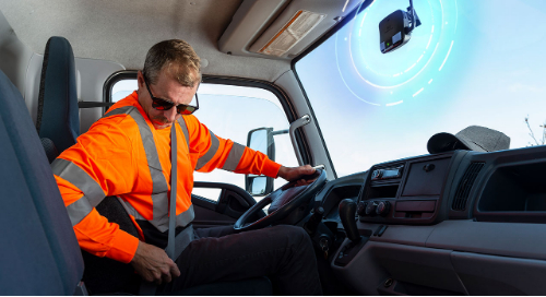 truck driver with in-cab fleet safety technology