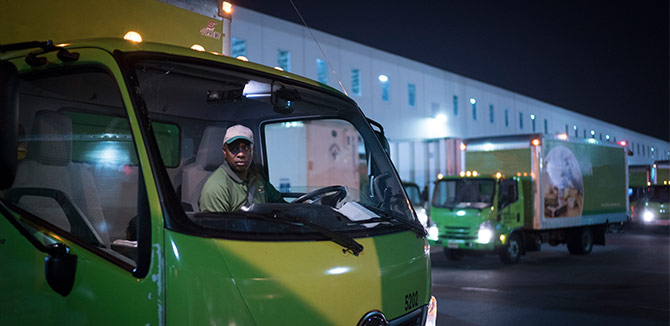 Driver in the cab of a vehicle at night