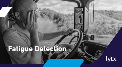 commercial driver visibly fatigued behind the wheel rubbing face
