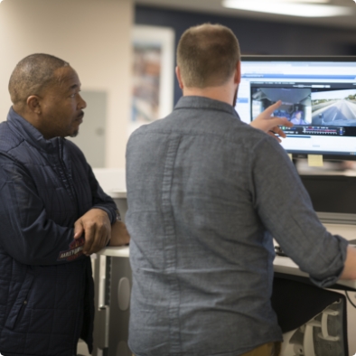 Two men looking at computer screen