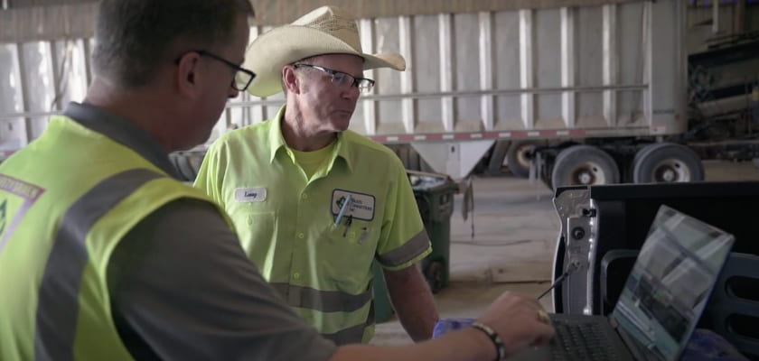 Waste Connections workers looking at laptop