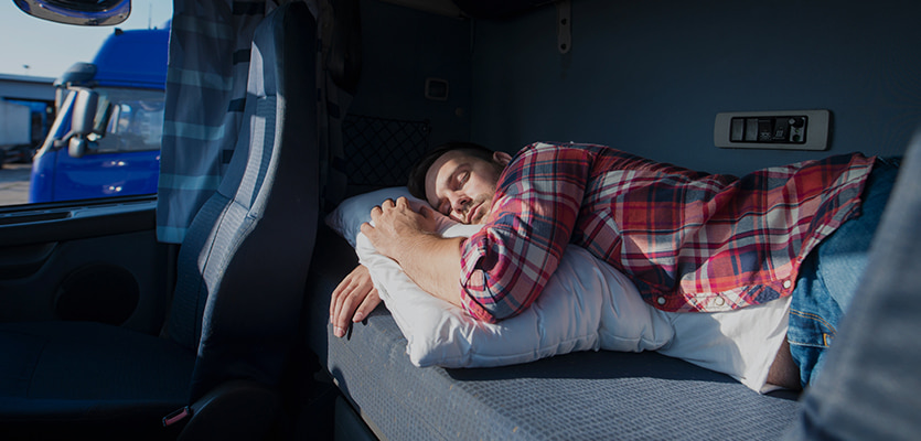 driver sleeping in a truck sleeper berth